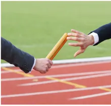 passing of a baton on a running track