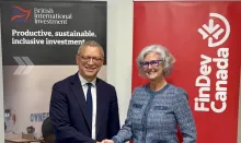 Leslie Maasdorp and Lori Kerr shaking hands