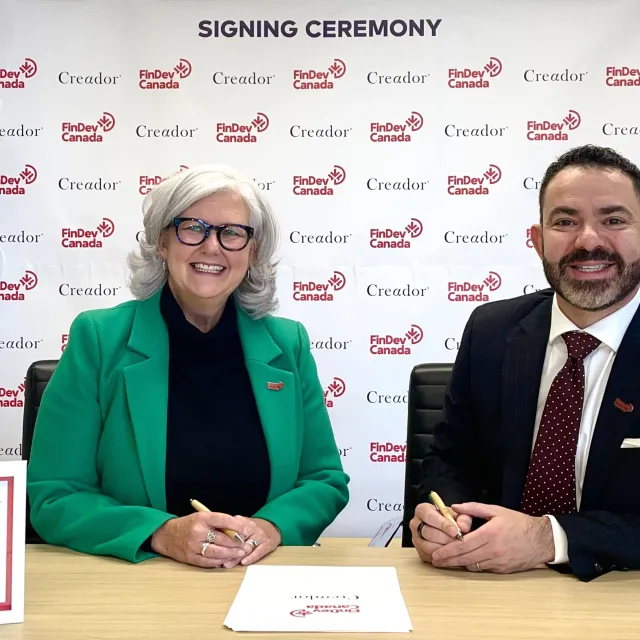 Lori and Omar smiling during signing ceremony