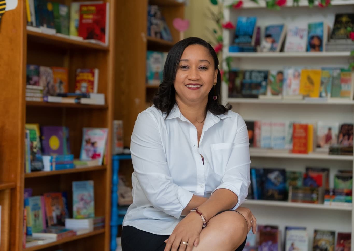 Une femme assise dans sa librairie