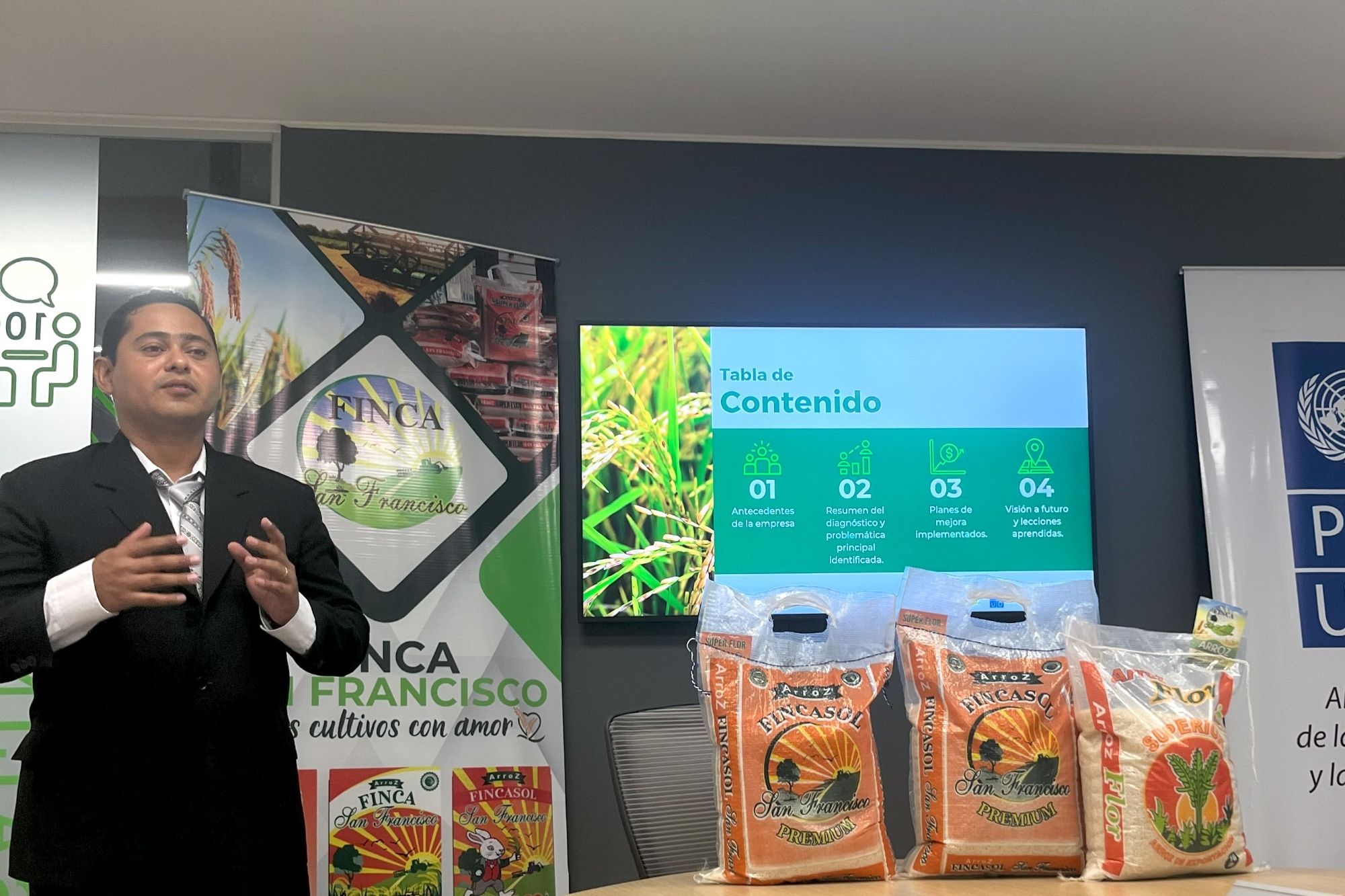 A suited man doing a presentation of farm products, company FINCA San Francisco